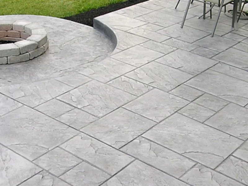 Stamped concrete exterior surface with a moulded flagstone pattern correctly installed over an assessed drainage base